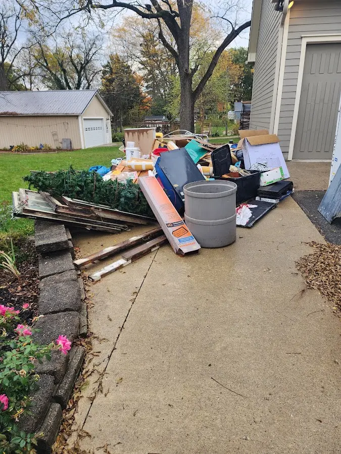 Dumpster being loaded with debris for 12 Yard Dumpster Rental in Blendon